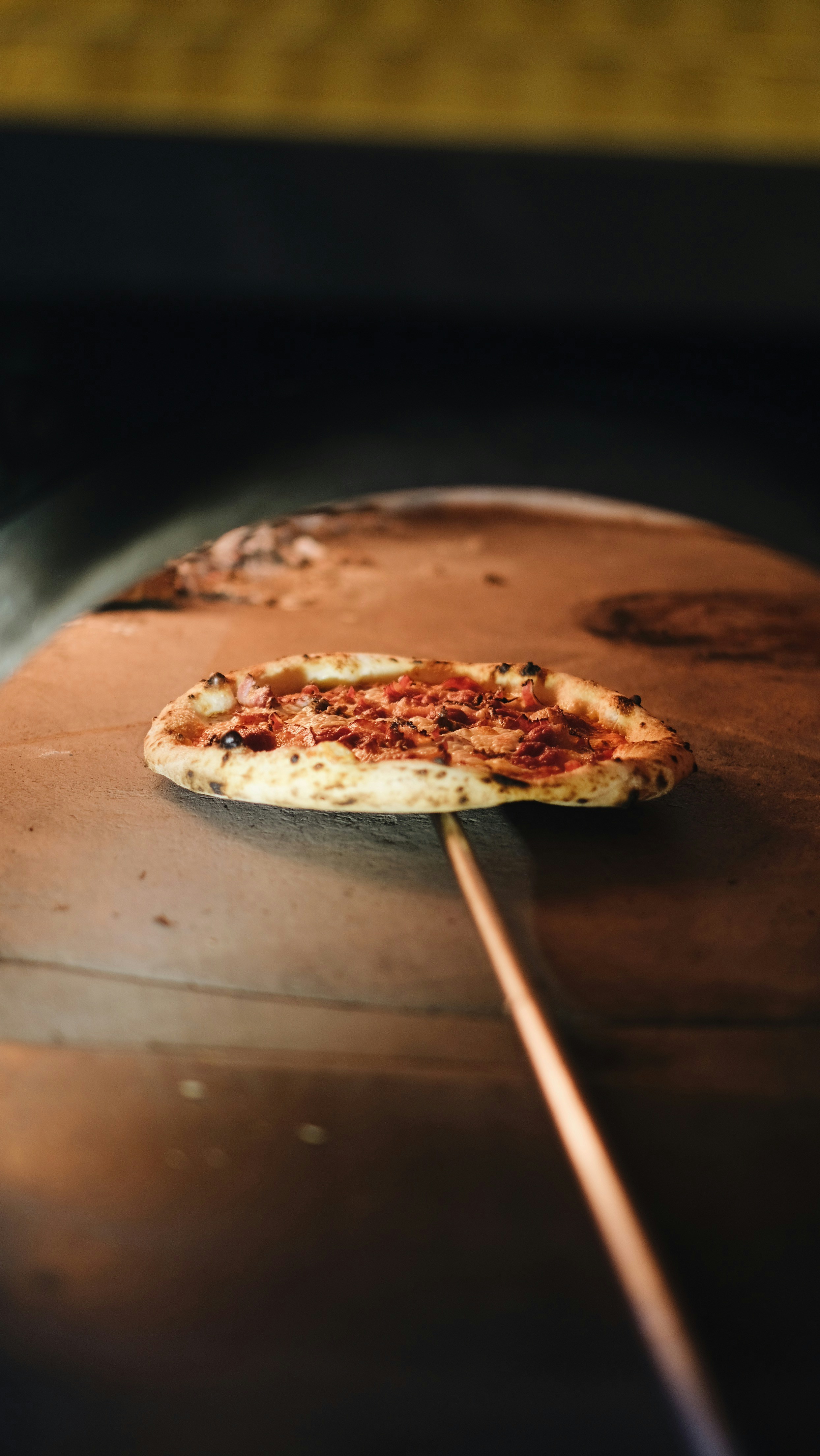 A pizza sitting on top of a pizza oven