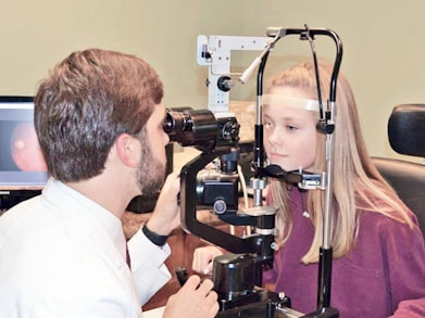 A man and a woman looking through a camera