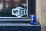 A can of soda sitting on a window sill