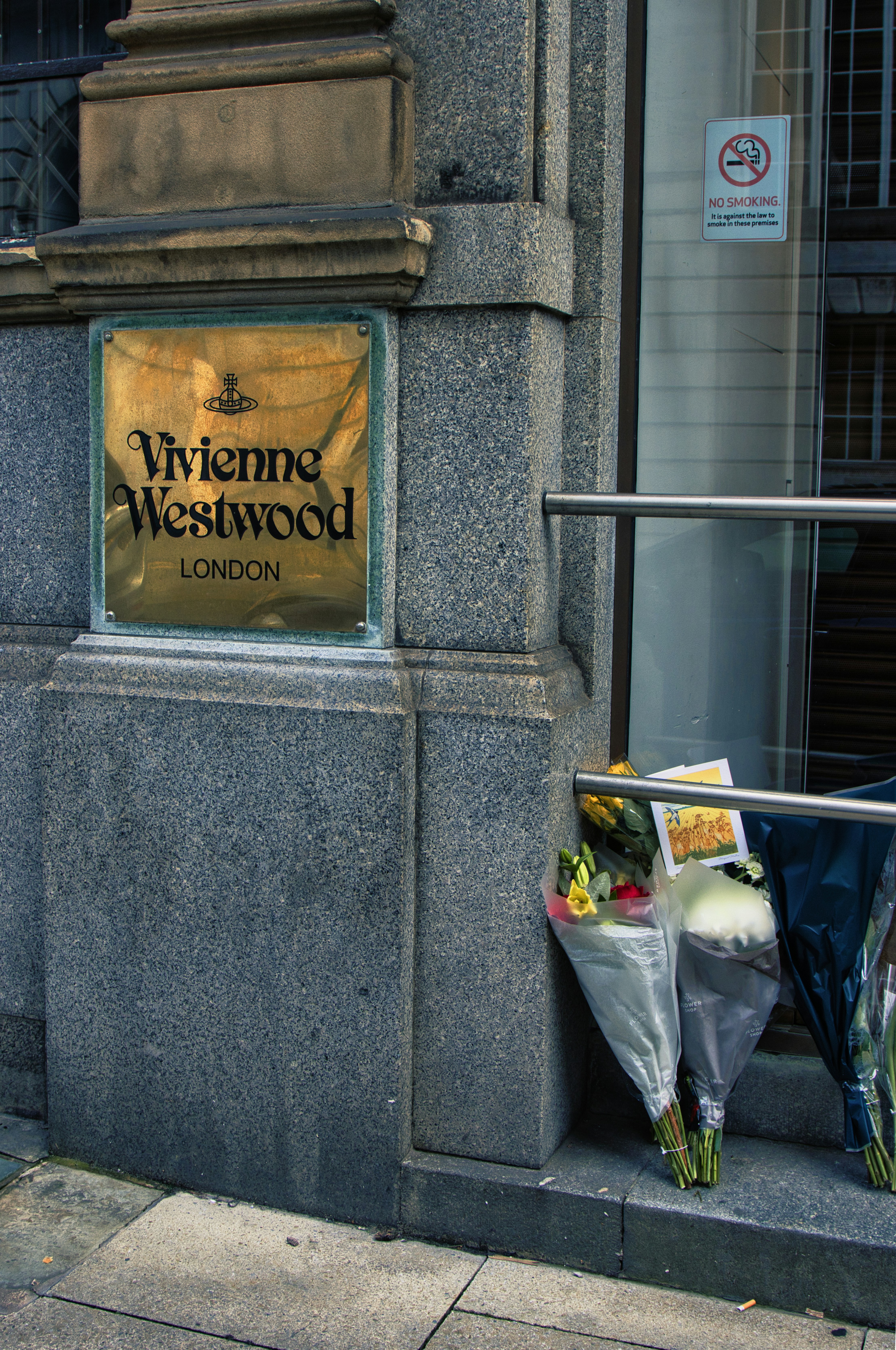 A bunch of flowers that are on the side of a building