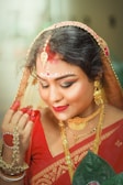 A woman in a red sari and gold jewelry