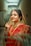 A woman in a red and gold sari