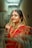A woman in a red and gold sari