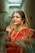 A woman in a red and gold sari