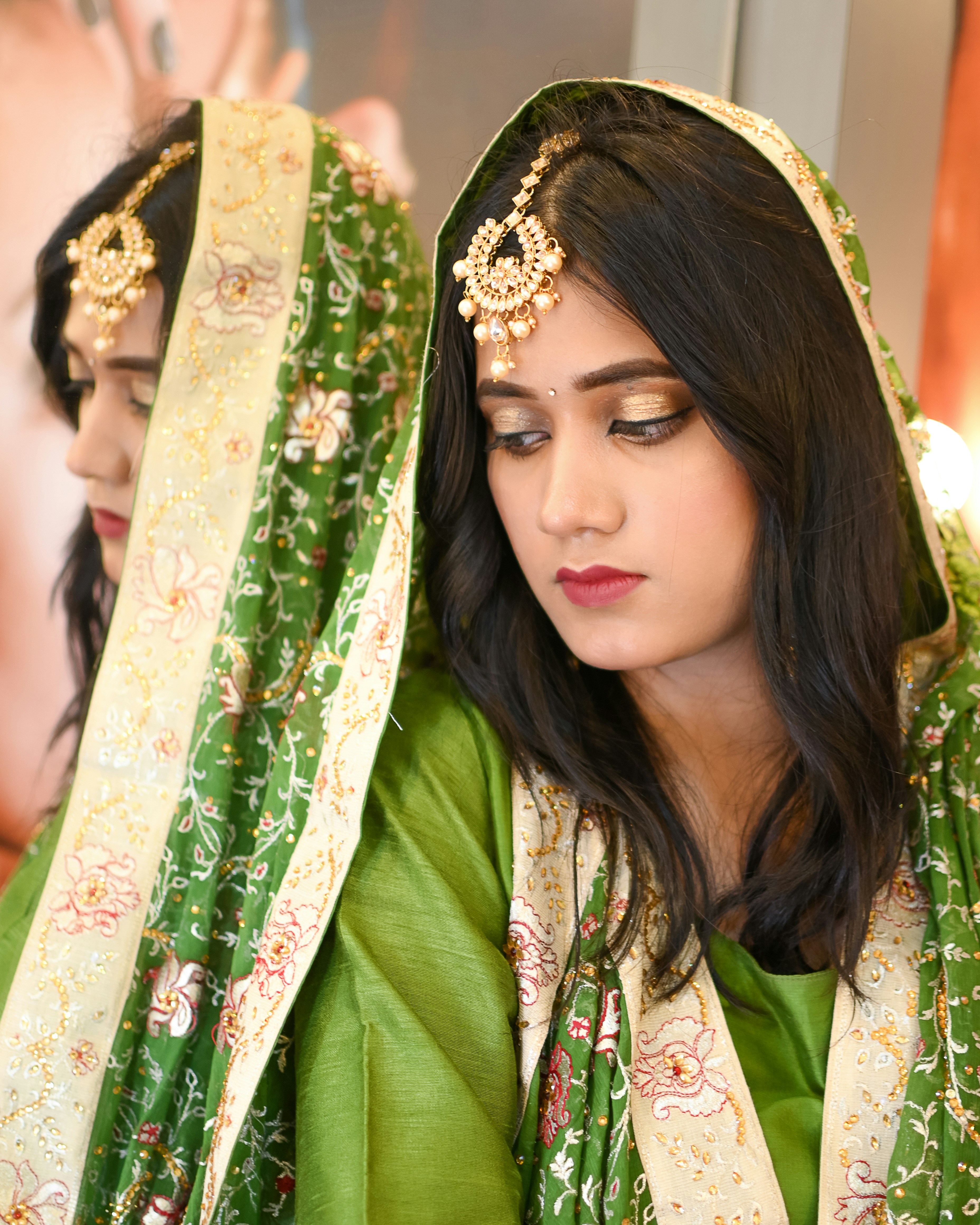 A woman in a green and white sari