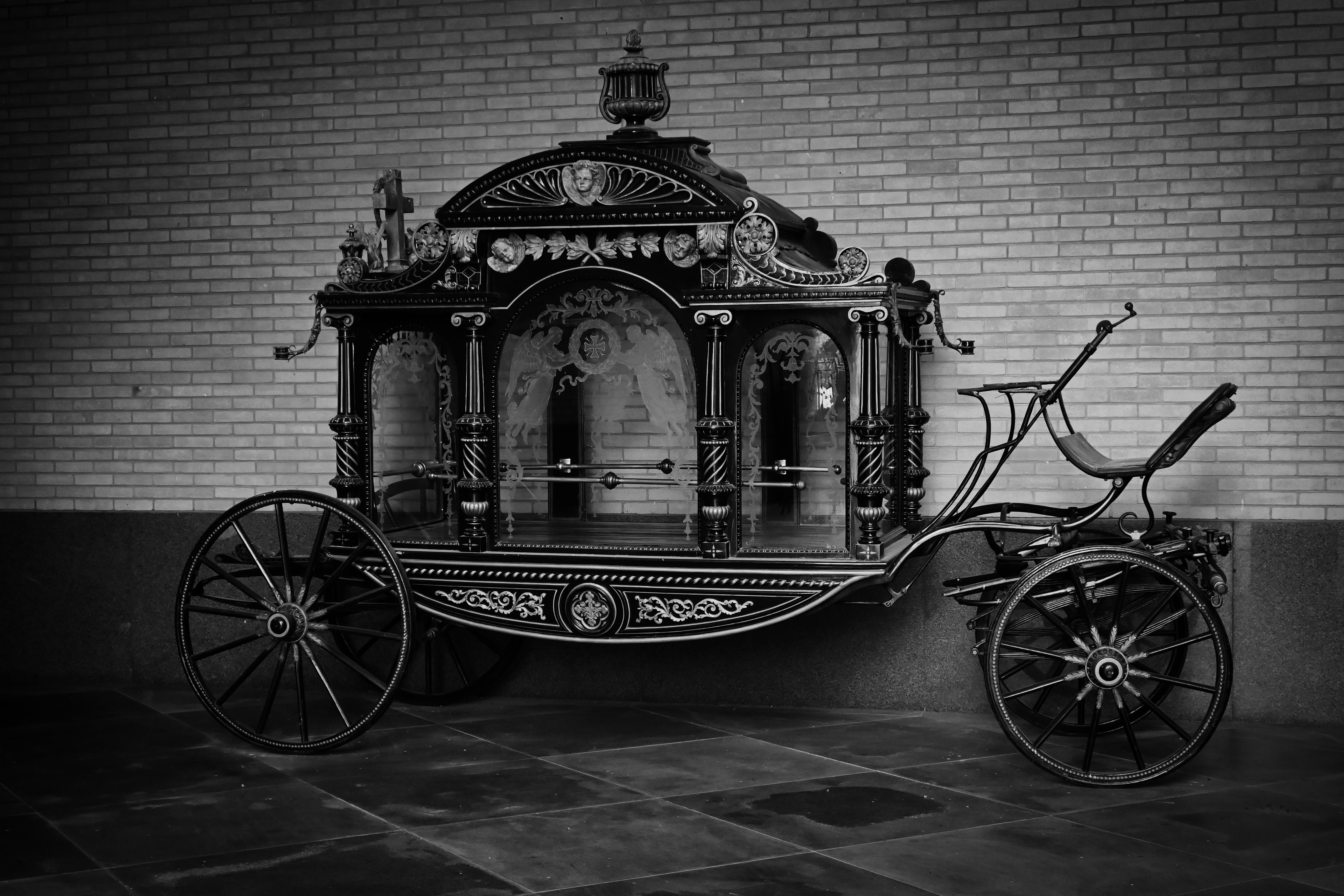 A black and white photo of a horse drawn carriage