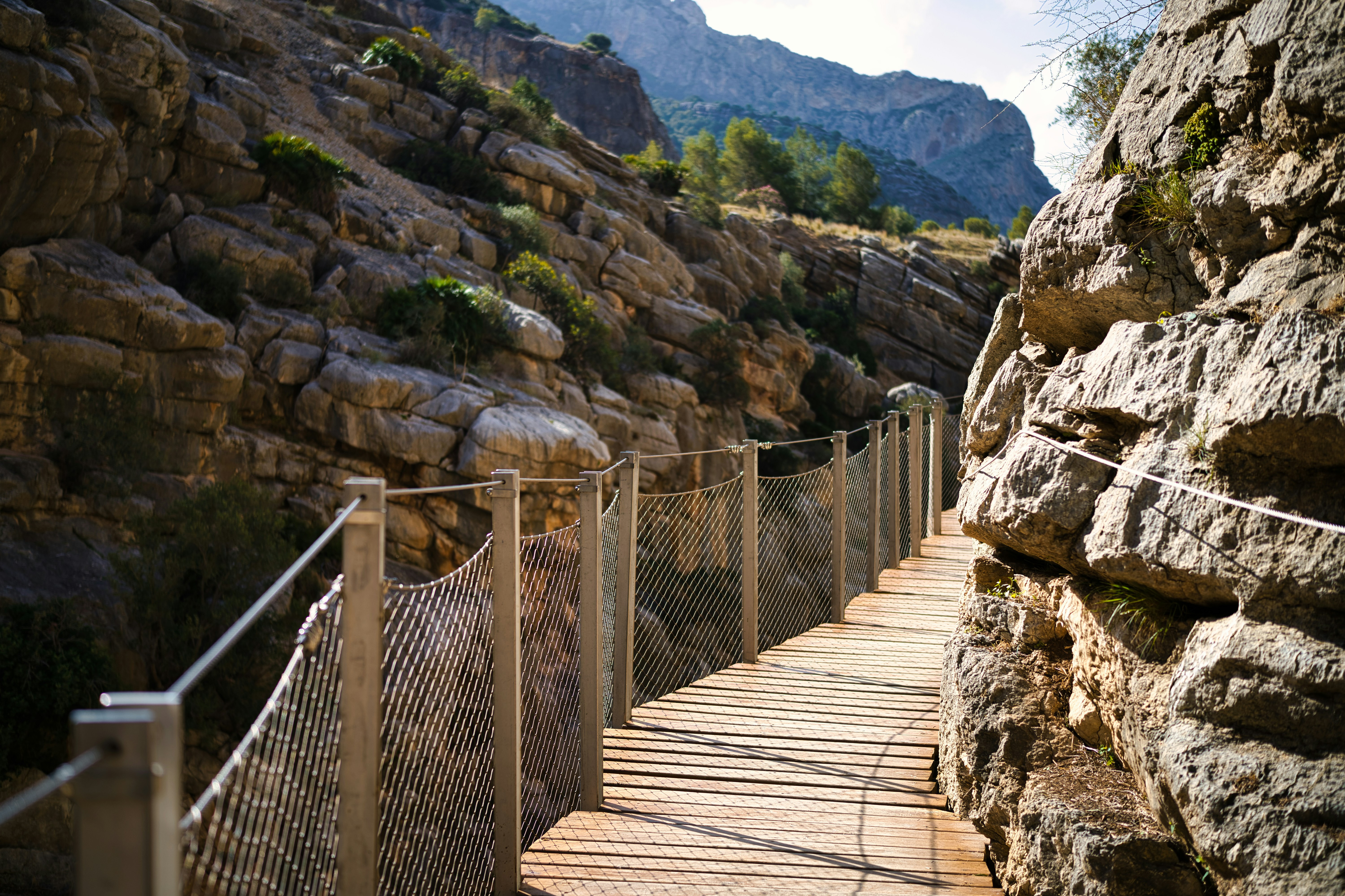 A wooden walkway going up a mountain side