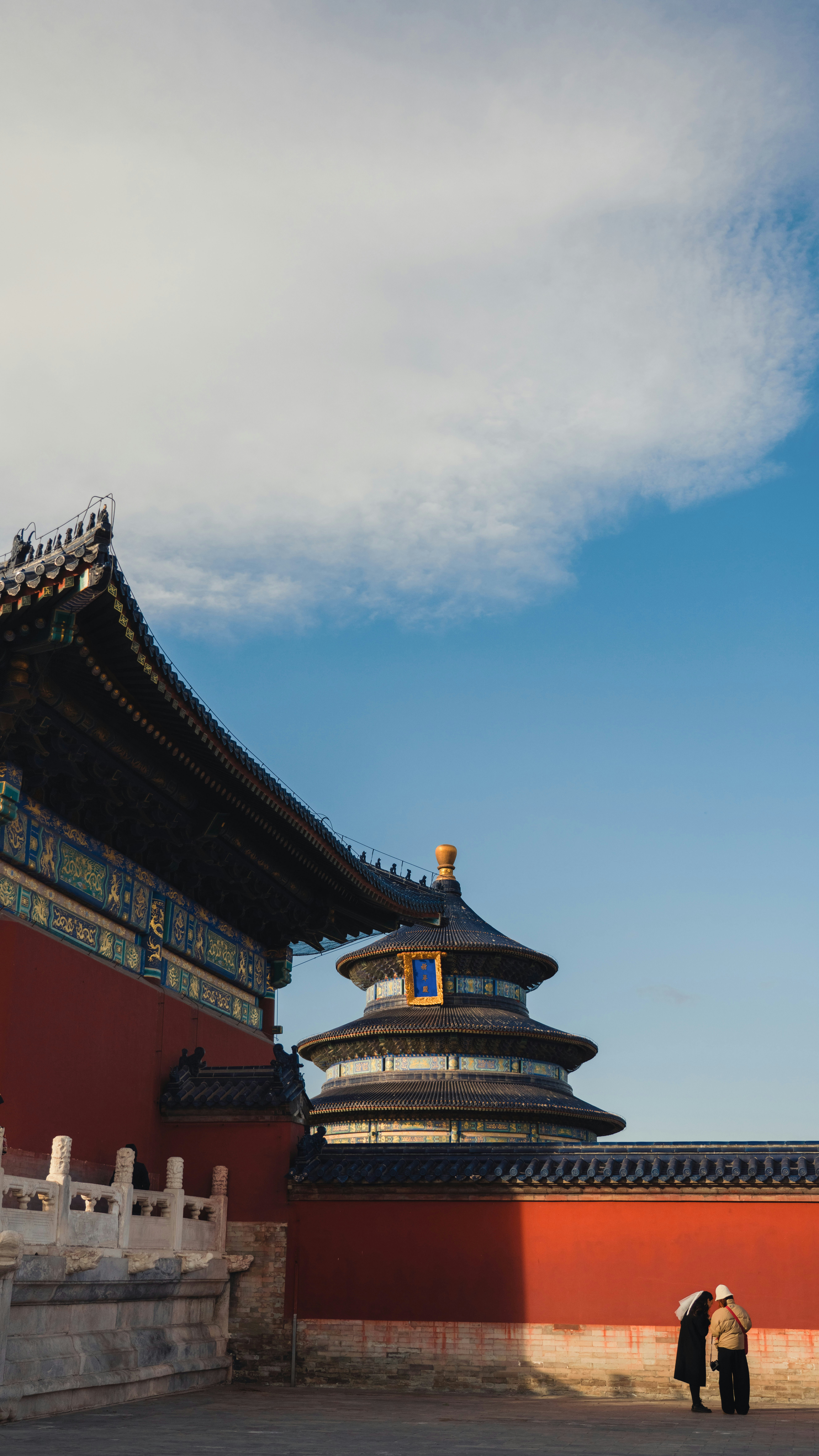 A man and a woman standing in front of a building