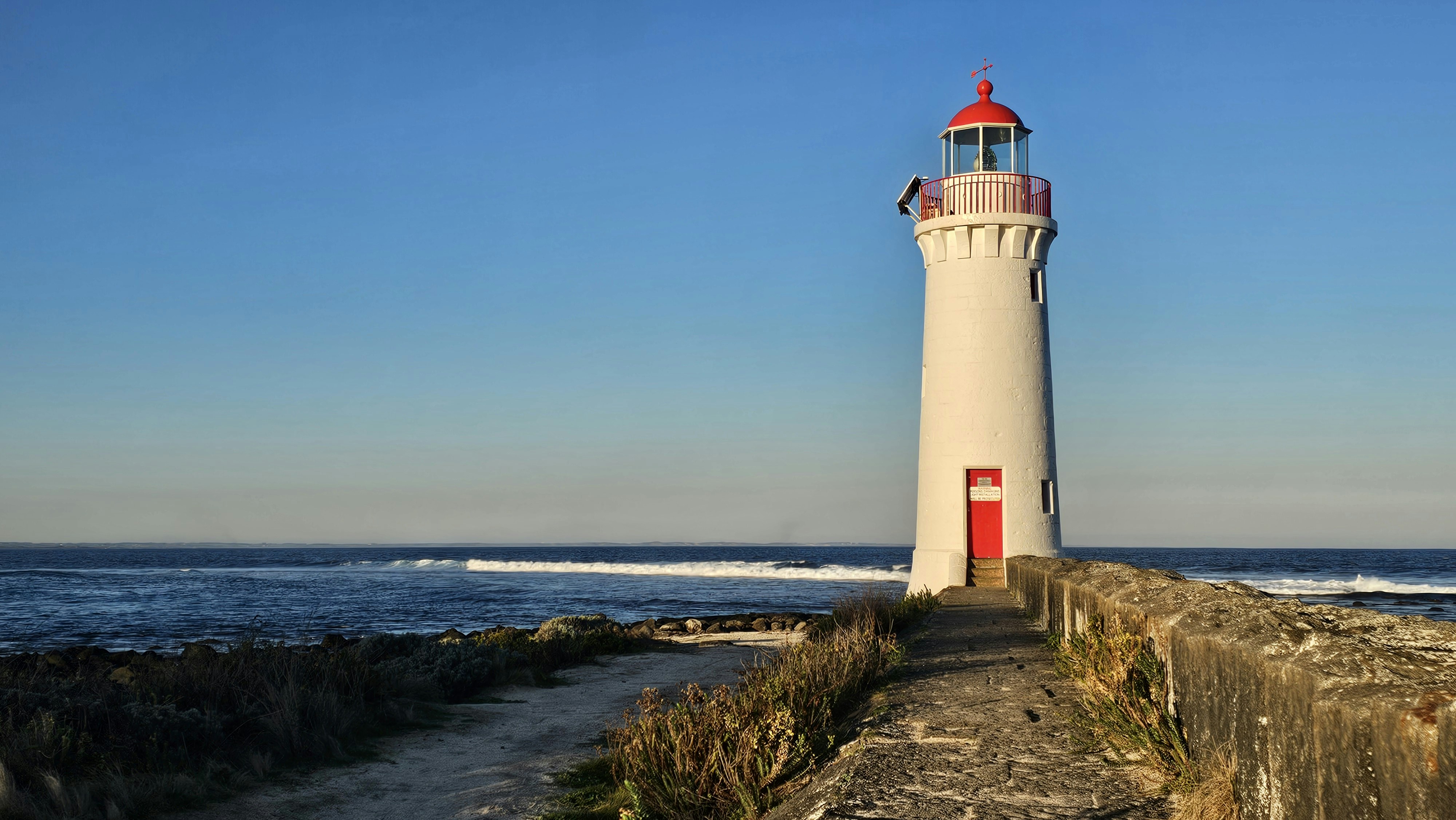 A light house sitting on top of a sandy beach
