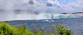 A view of the niagara falls from the side of the river