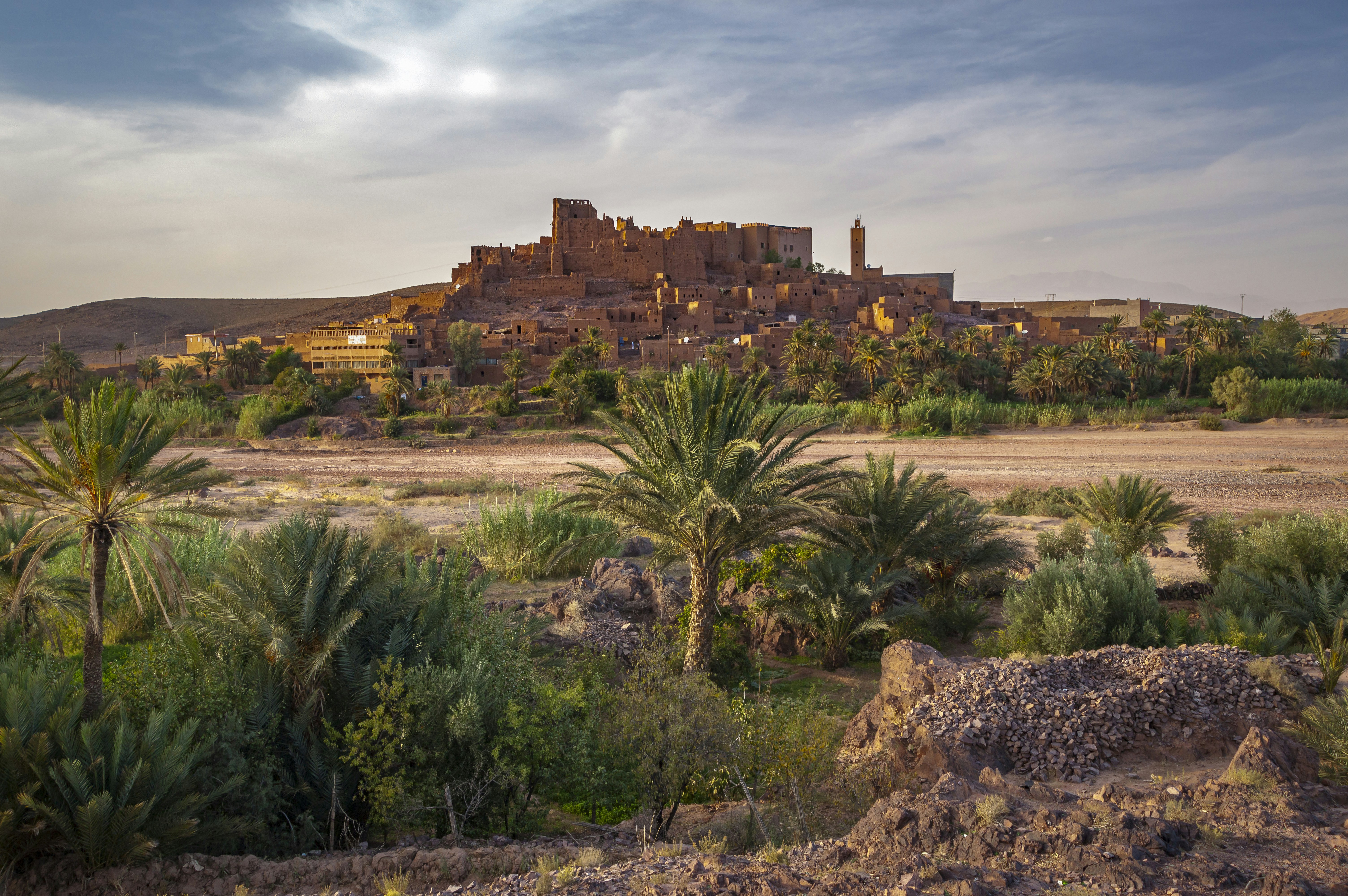 A large building sitting on top of a lush green hillside