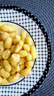 A white plate topped with macaroni and cheese