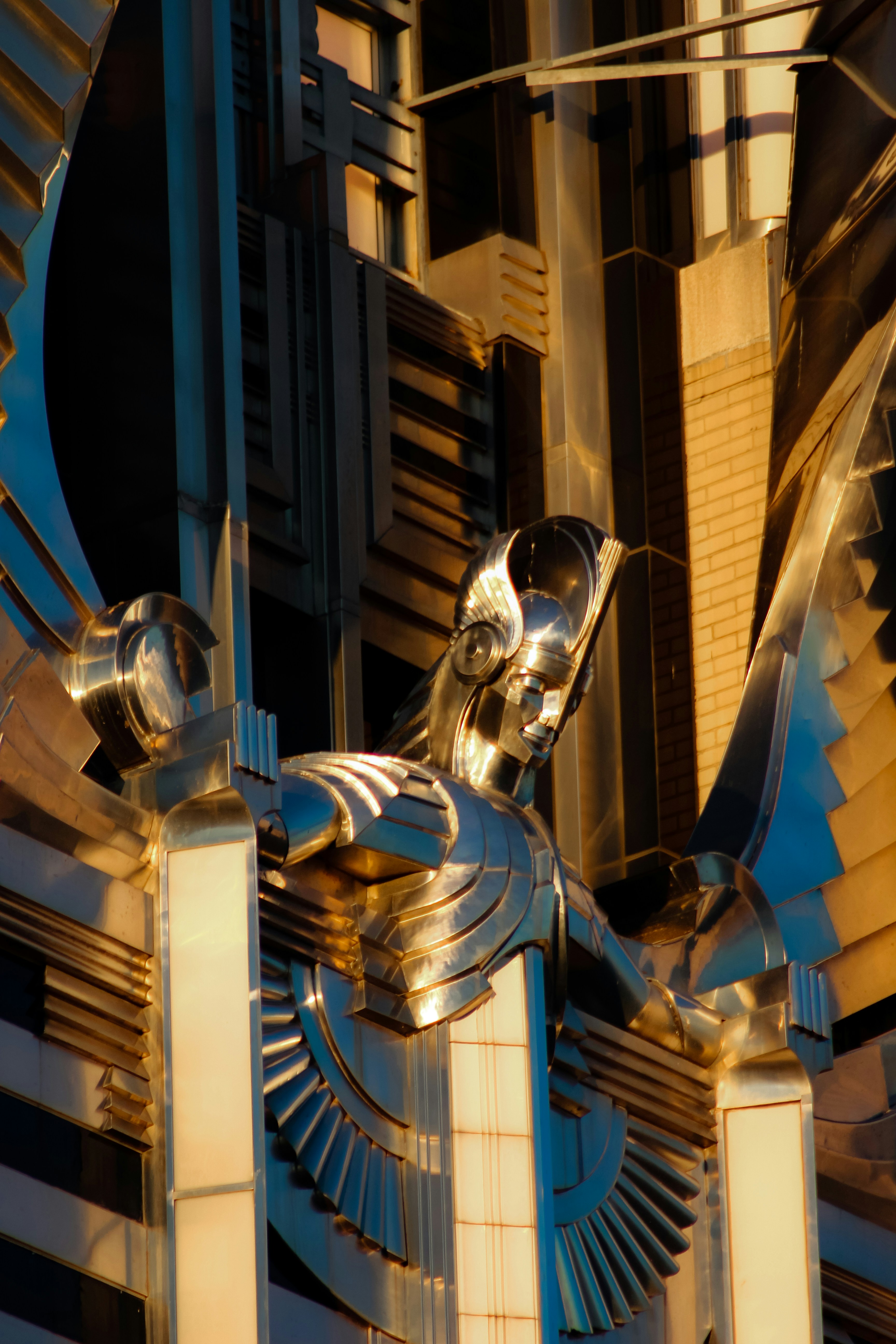 A sculpture of a winged bird on top of a building