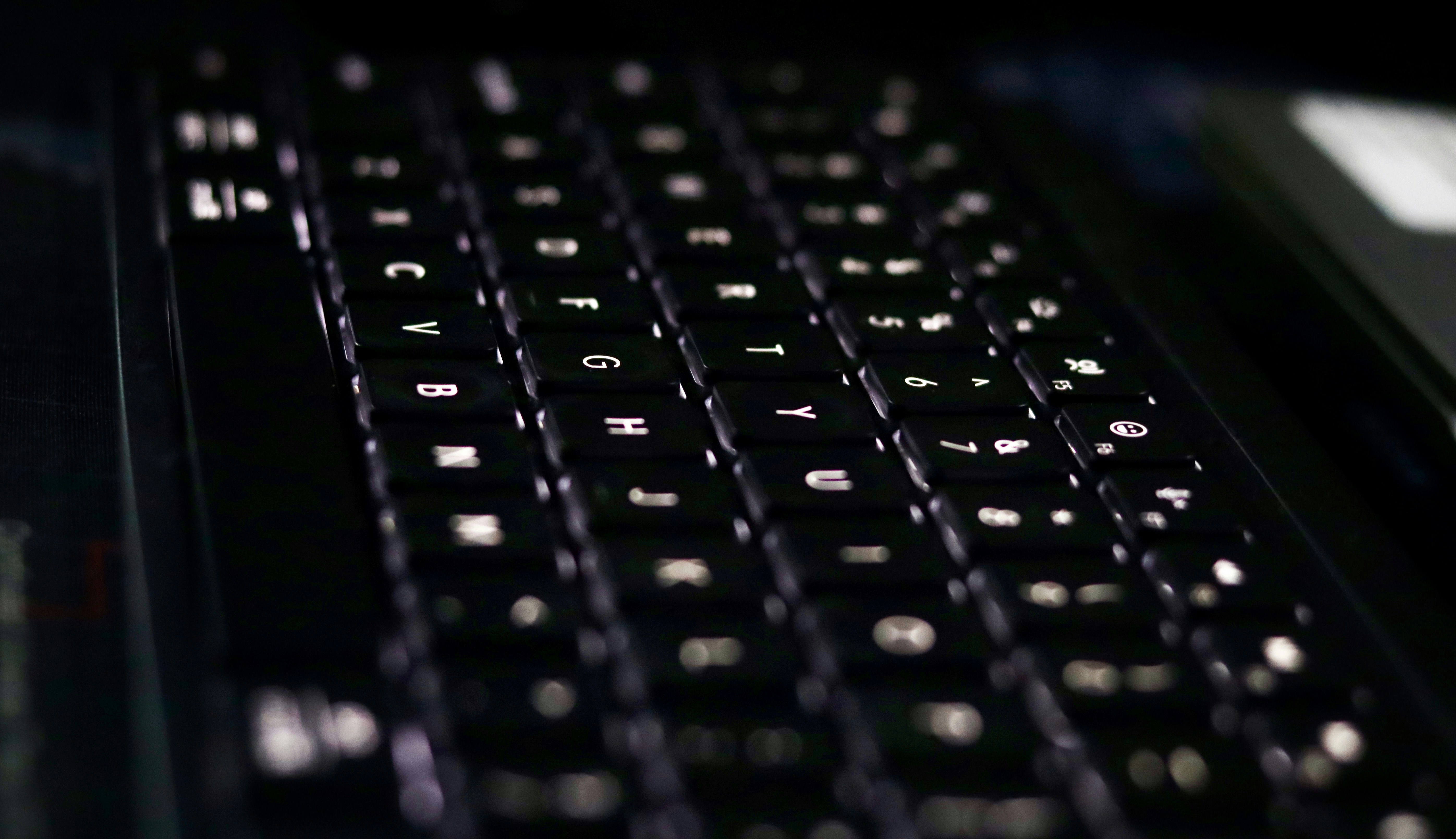 A close up of a black keyboard on a desk