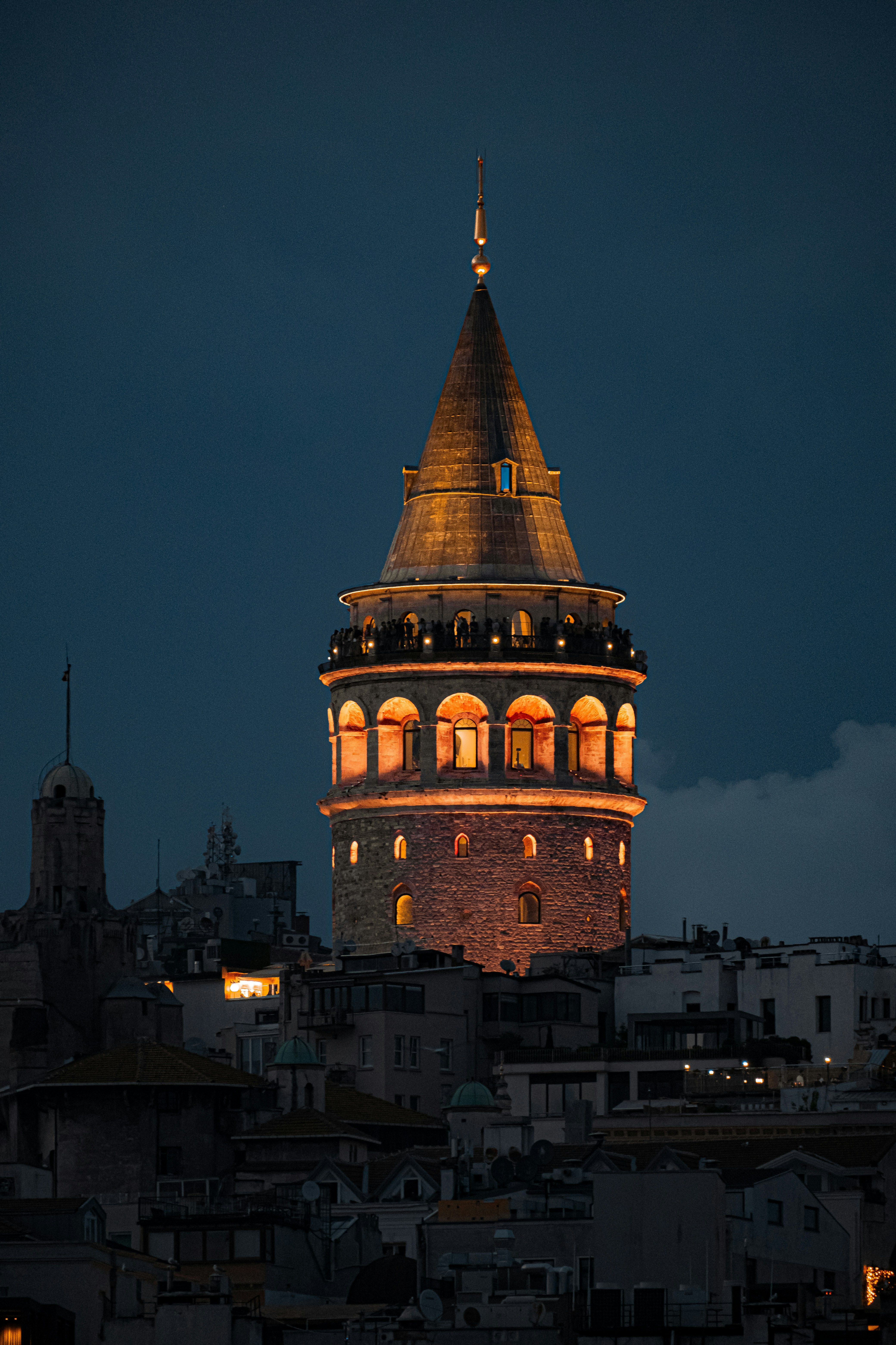 A very tall tower with a clock on it's side