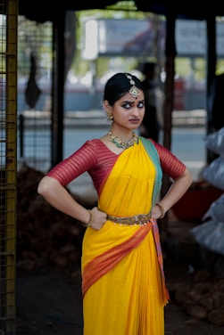 A woman in a yellow and red sari