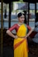 A woman in a yellow and red sari