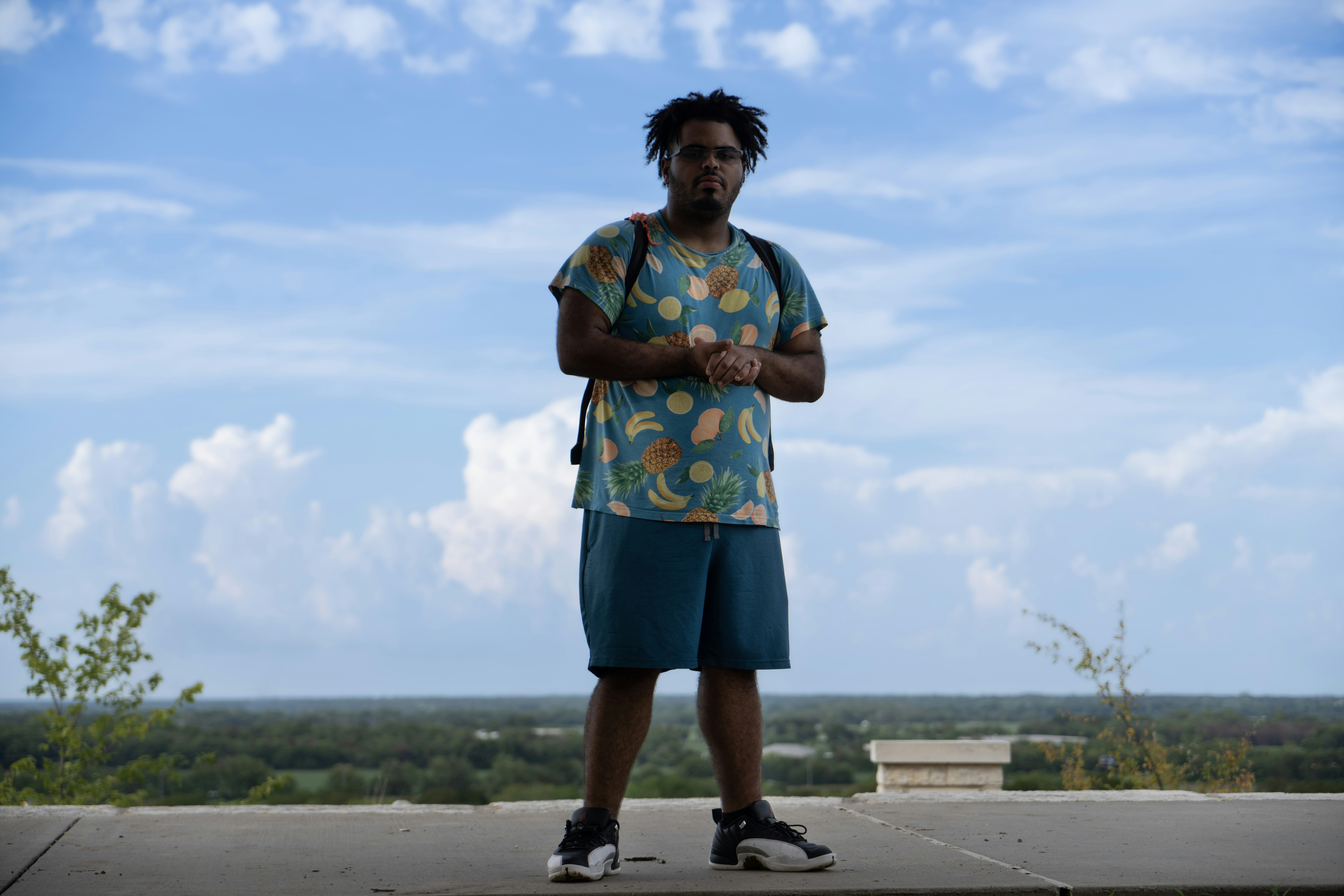 A man is standing on a skateboard on a ledge