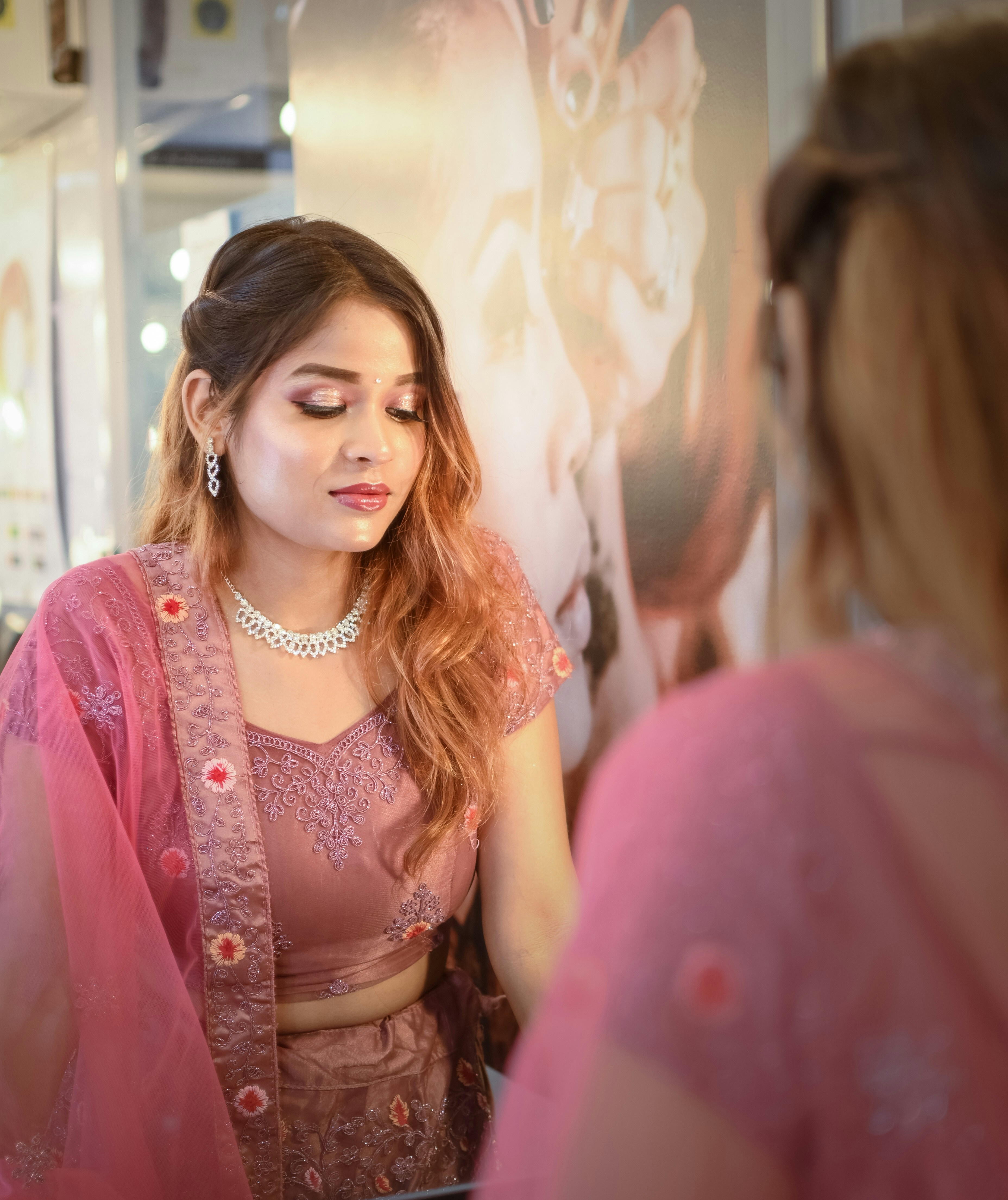 A woman standing in front of a mirror