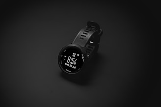 A smart watch sitting on top of a black surface