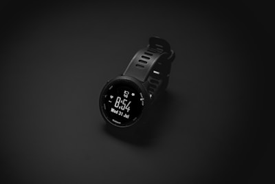A smart watch sitting on top of a black surface