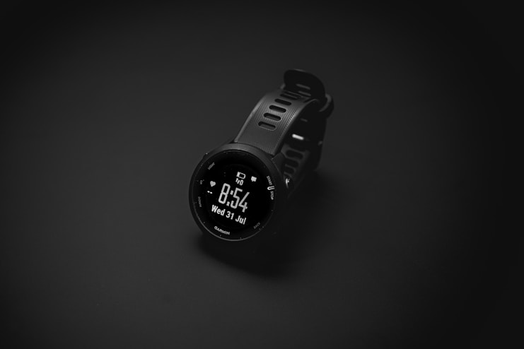 A smart watch sitting on top of a black surface