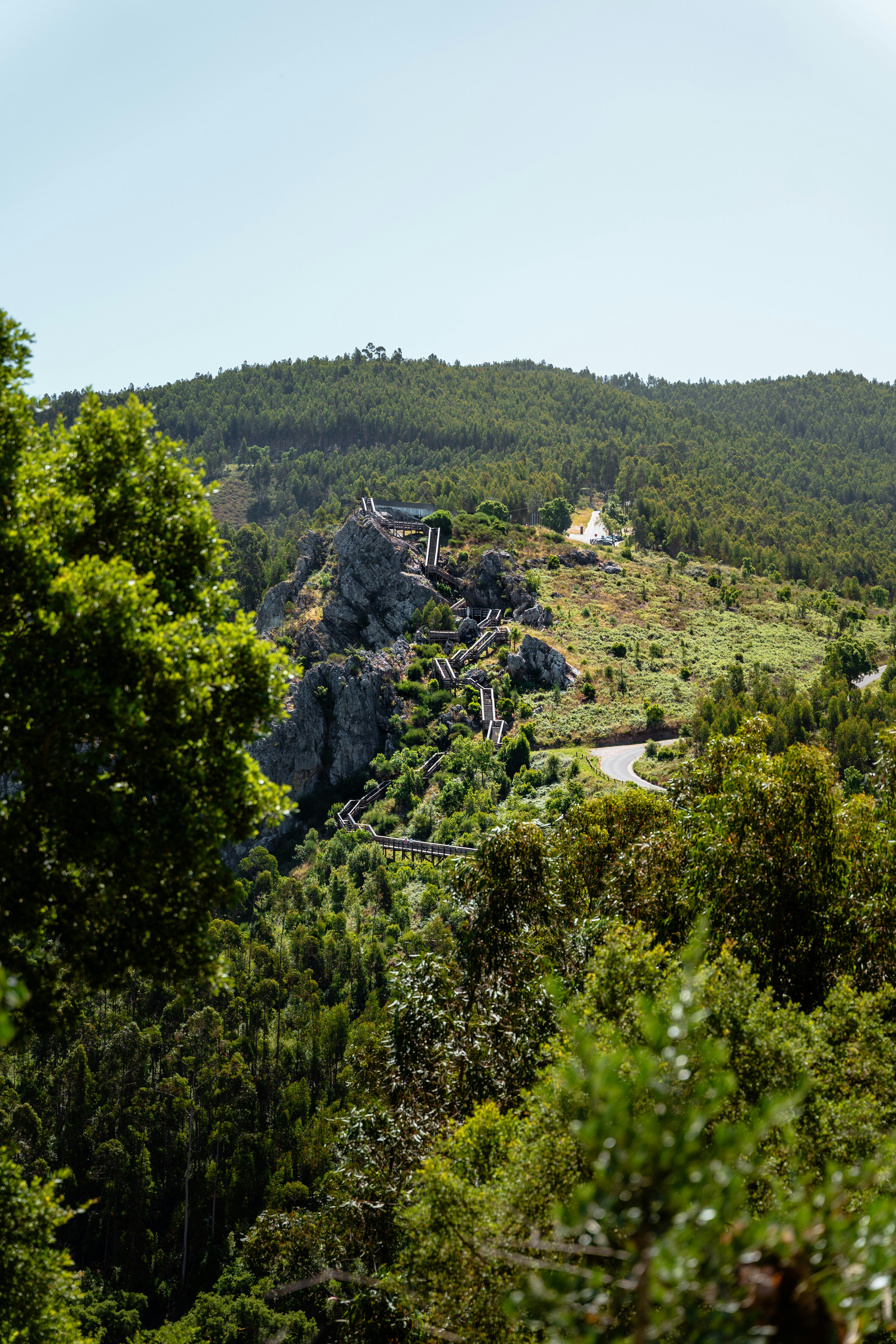 A scenic view of a mountain with a road going through it