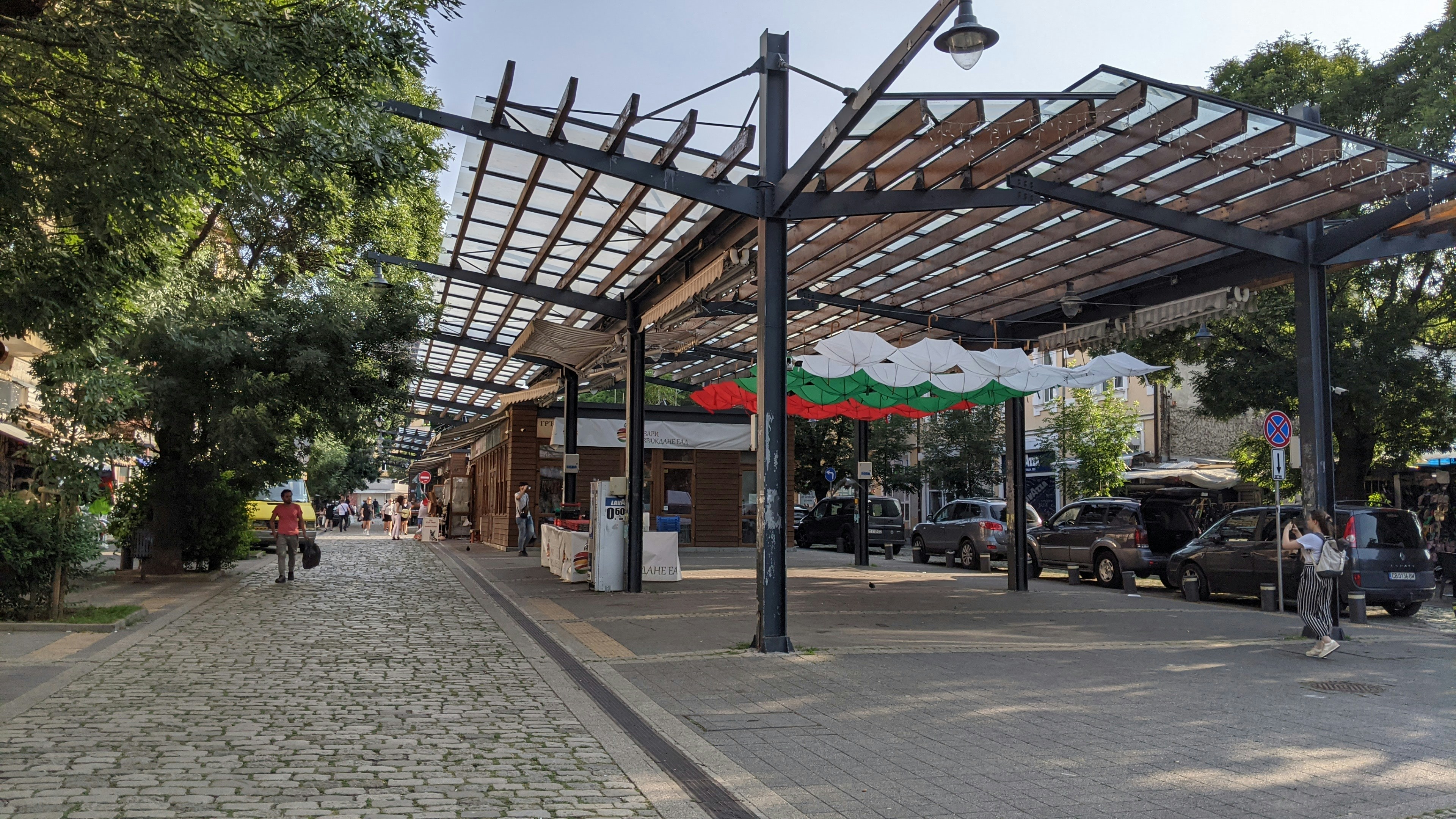A view of a street with cars parked on the side of it, 