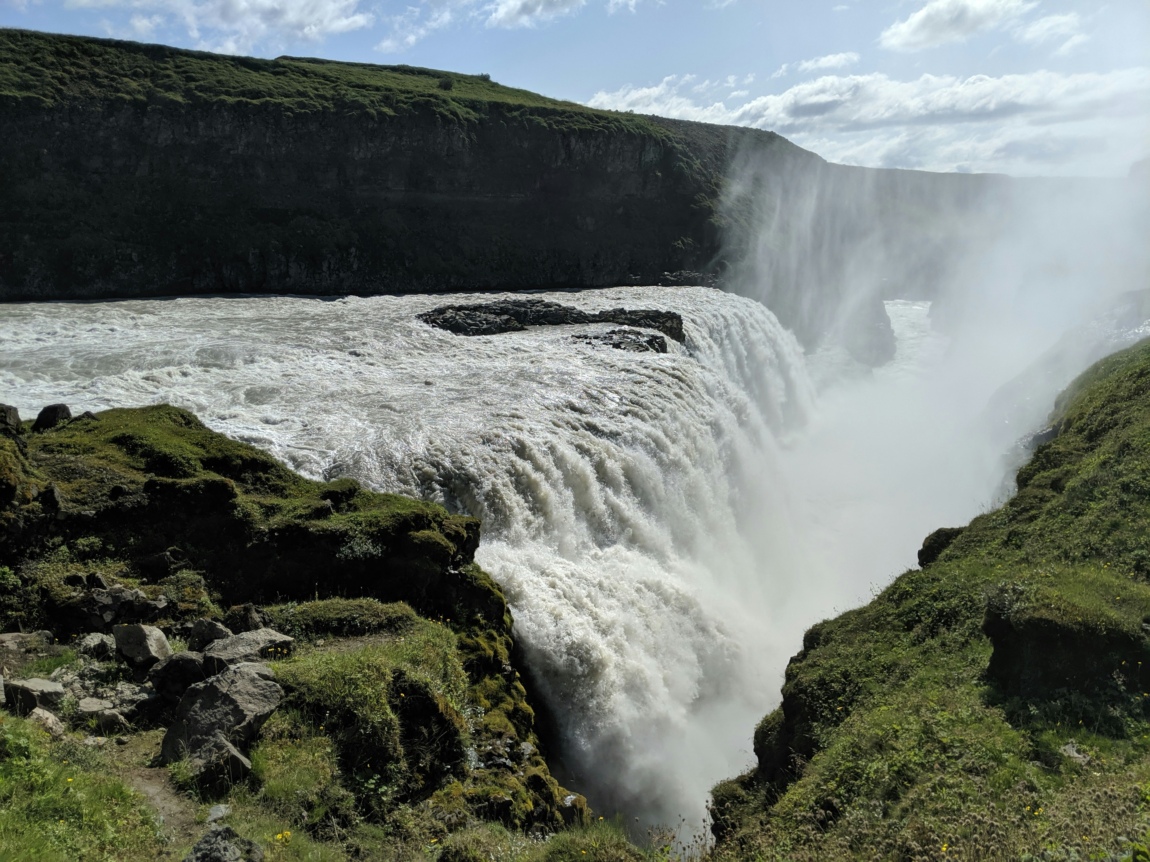 A view of a waterfall with water coming out of it