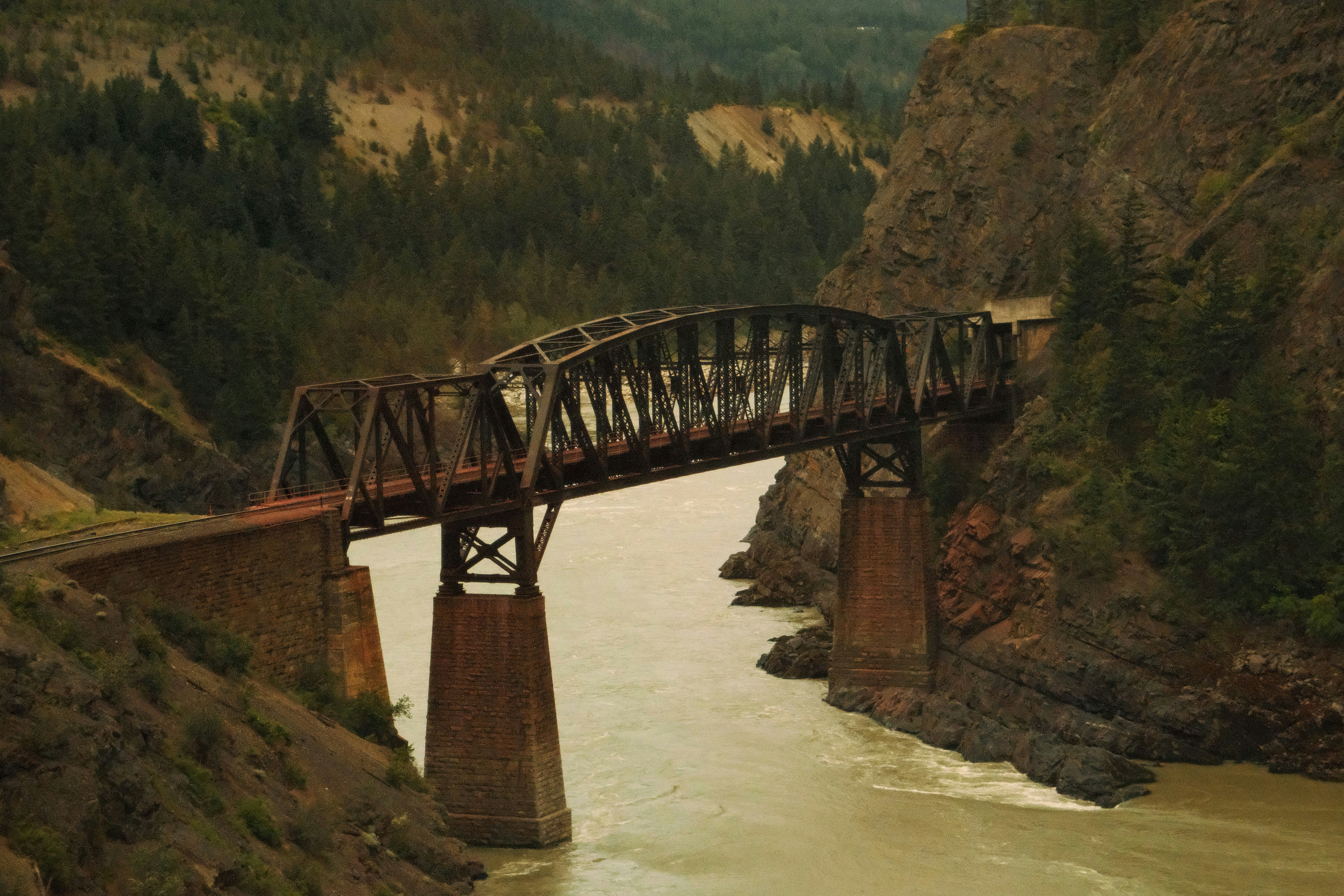 Train crossing river bridge