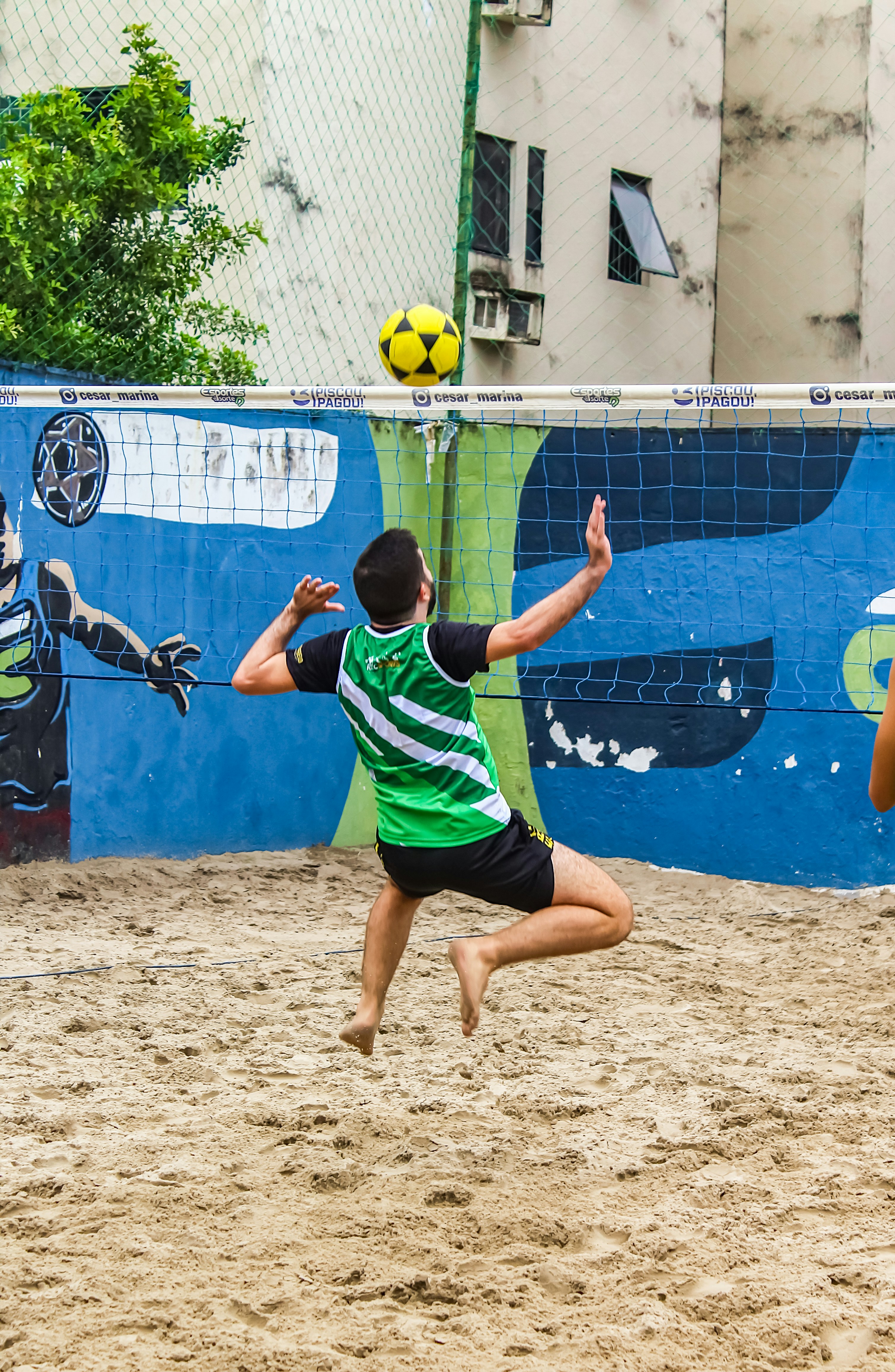 A group of young men playing a game of volleyball