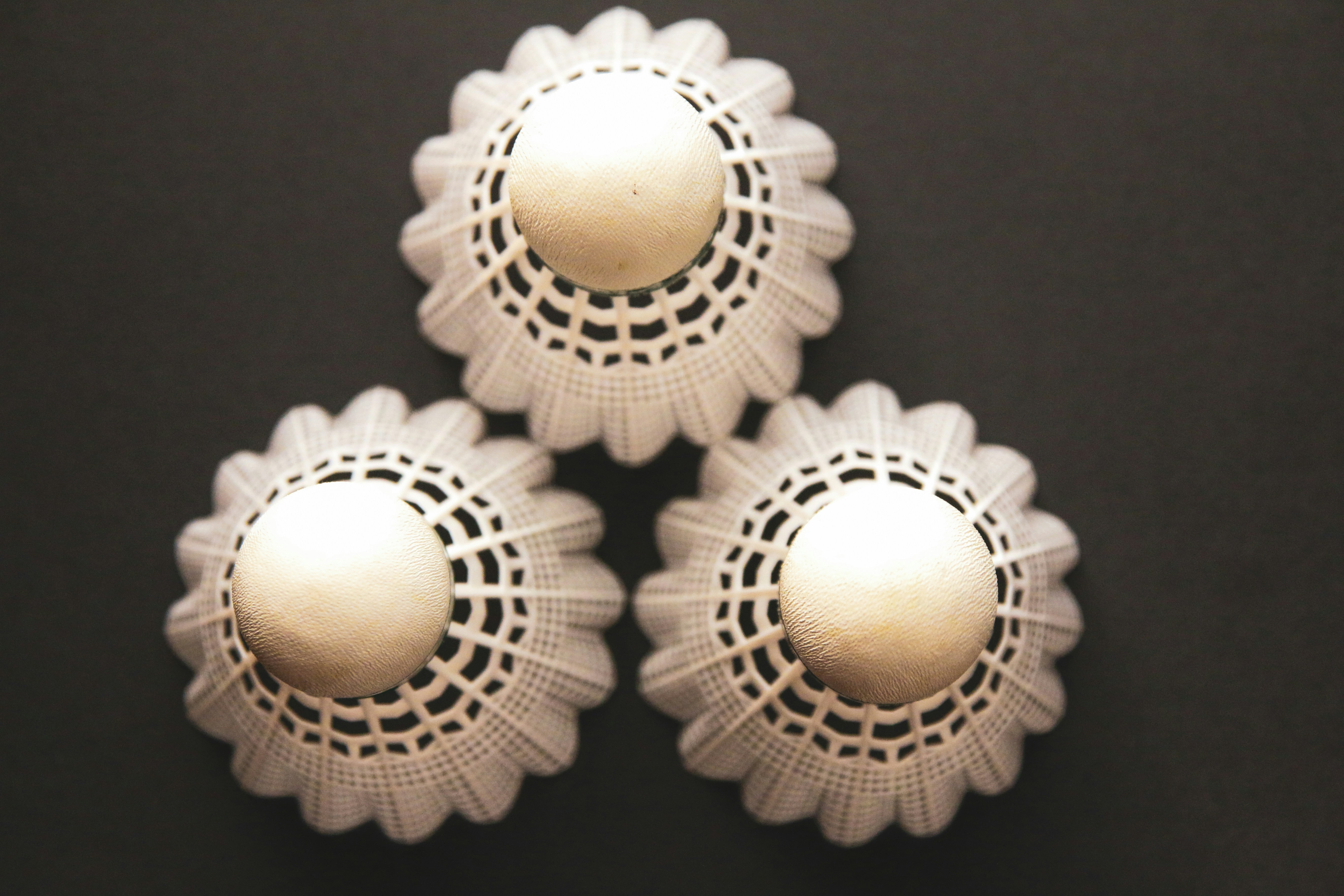 Three decorative knobs on a black surface