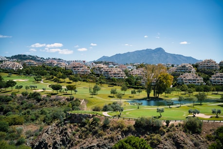A scenic view of a golf course and mountains