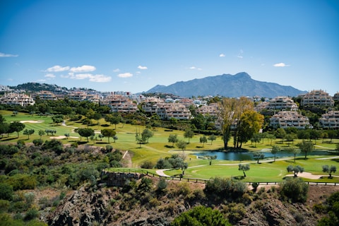 A scenic view of a golf course and mountains