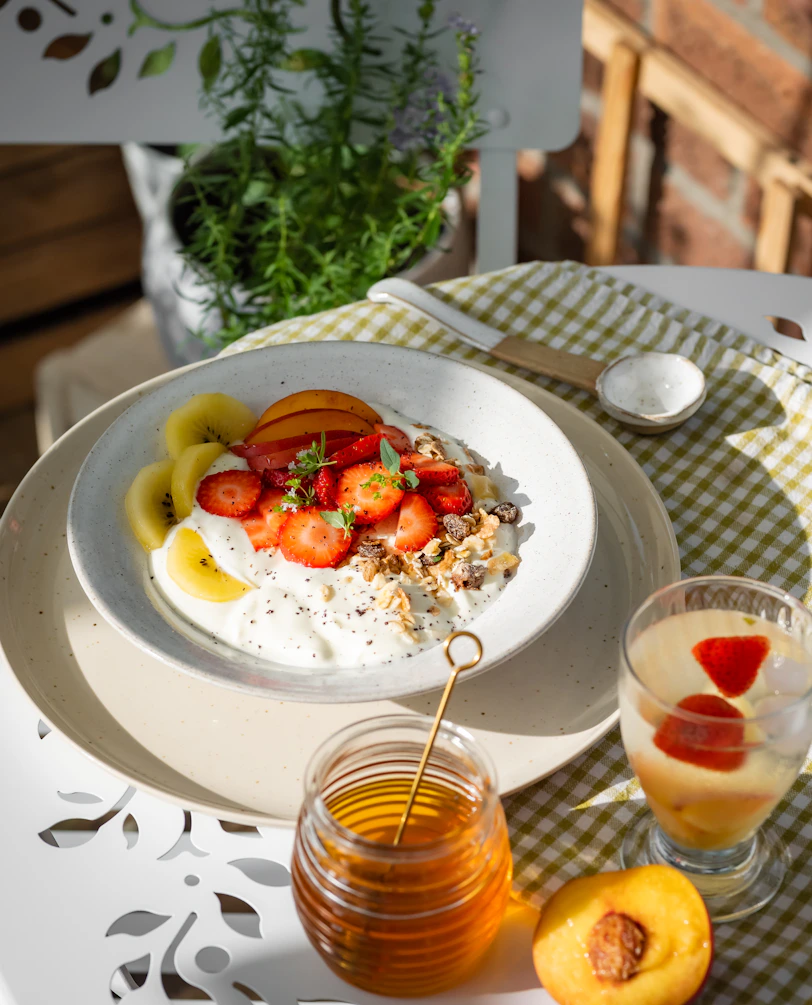 A plate of food on a table next to a glass of juice