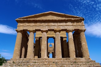 A large stone structure sitting on top of a lush green field