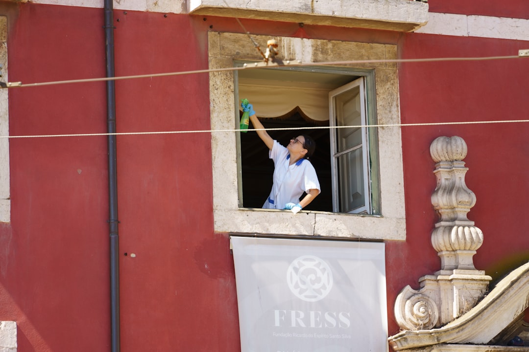 A man waving from a window of a building,