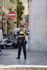 A police officer standing in the middle of a street