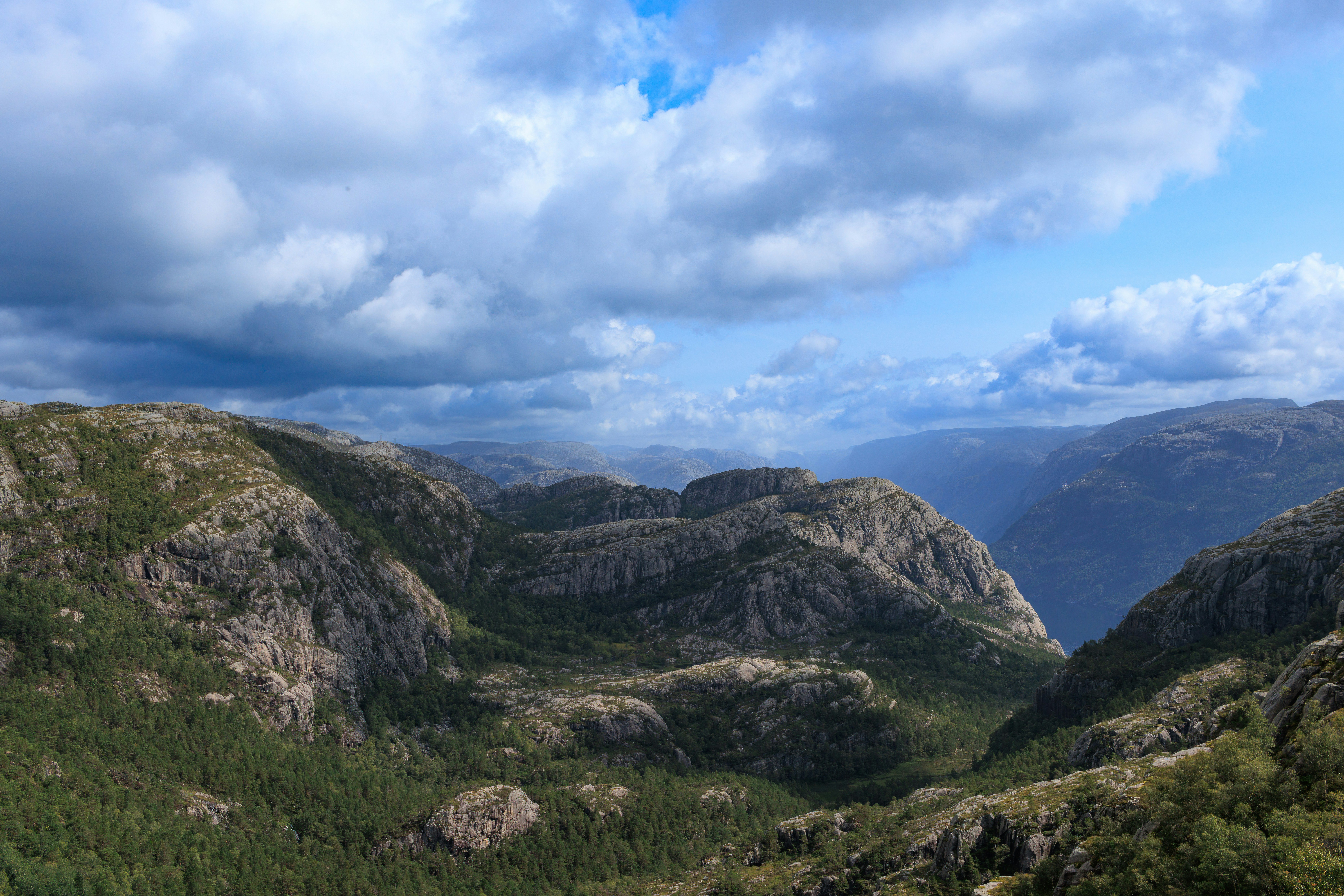 A scenic view of a mountain range with clouds in the sky, 3x2 aspect ratio. Taken on a hike up to Pulpit Rock. I crossed a bend and suddenly, there was this majestic view.