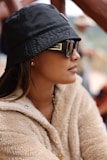 A woman wearing a black hat and sunglasses