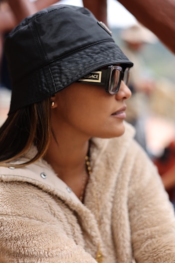 A woman wearing a black hat and sunglasses