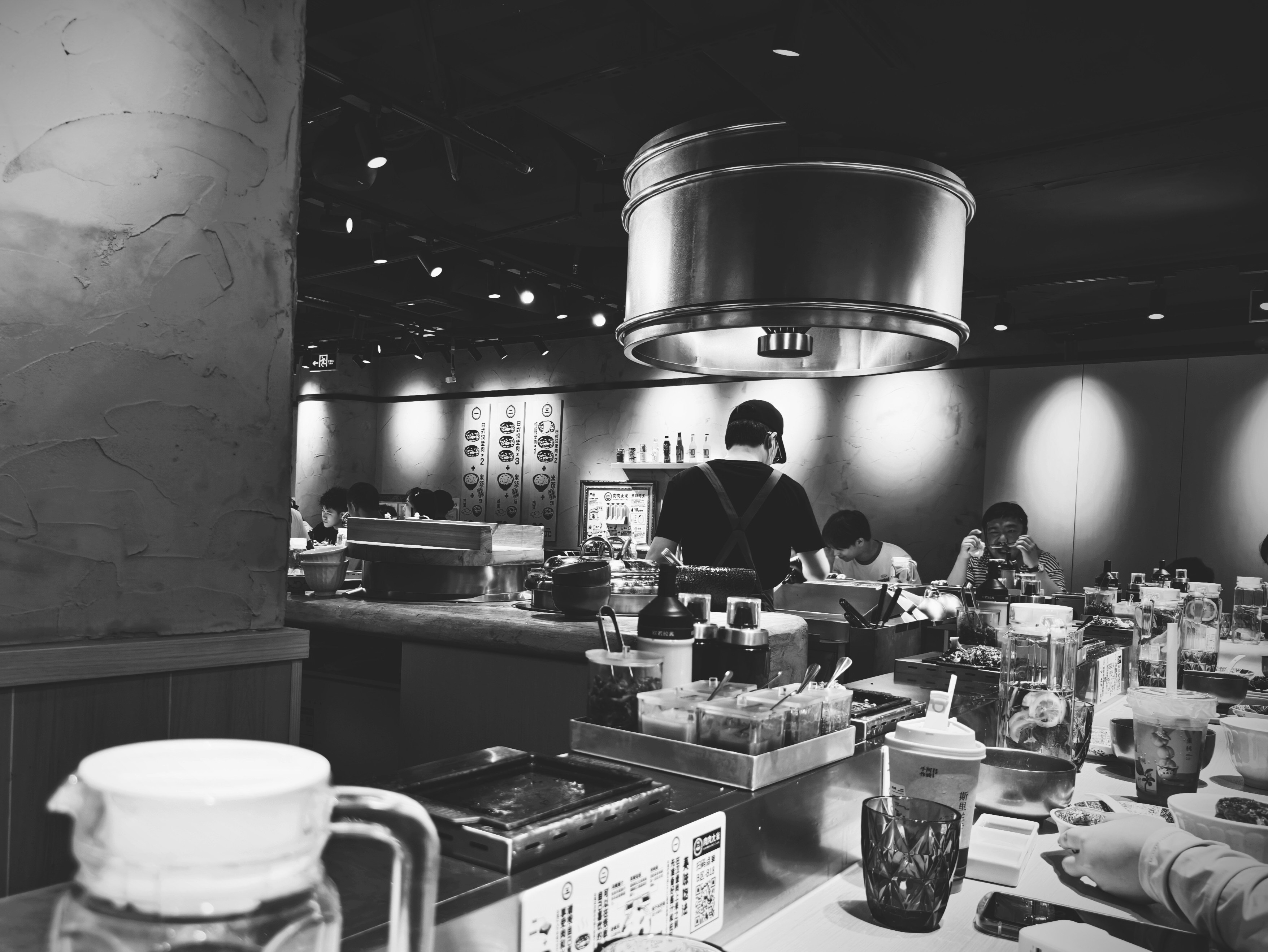 A black and white photo of people in a restaurant