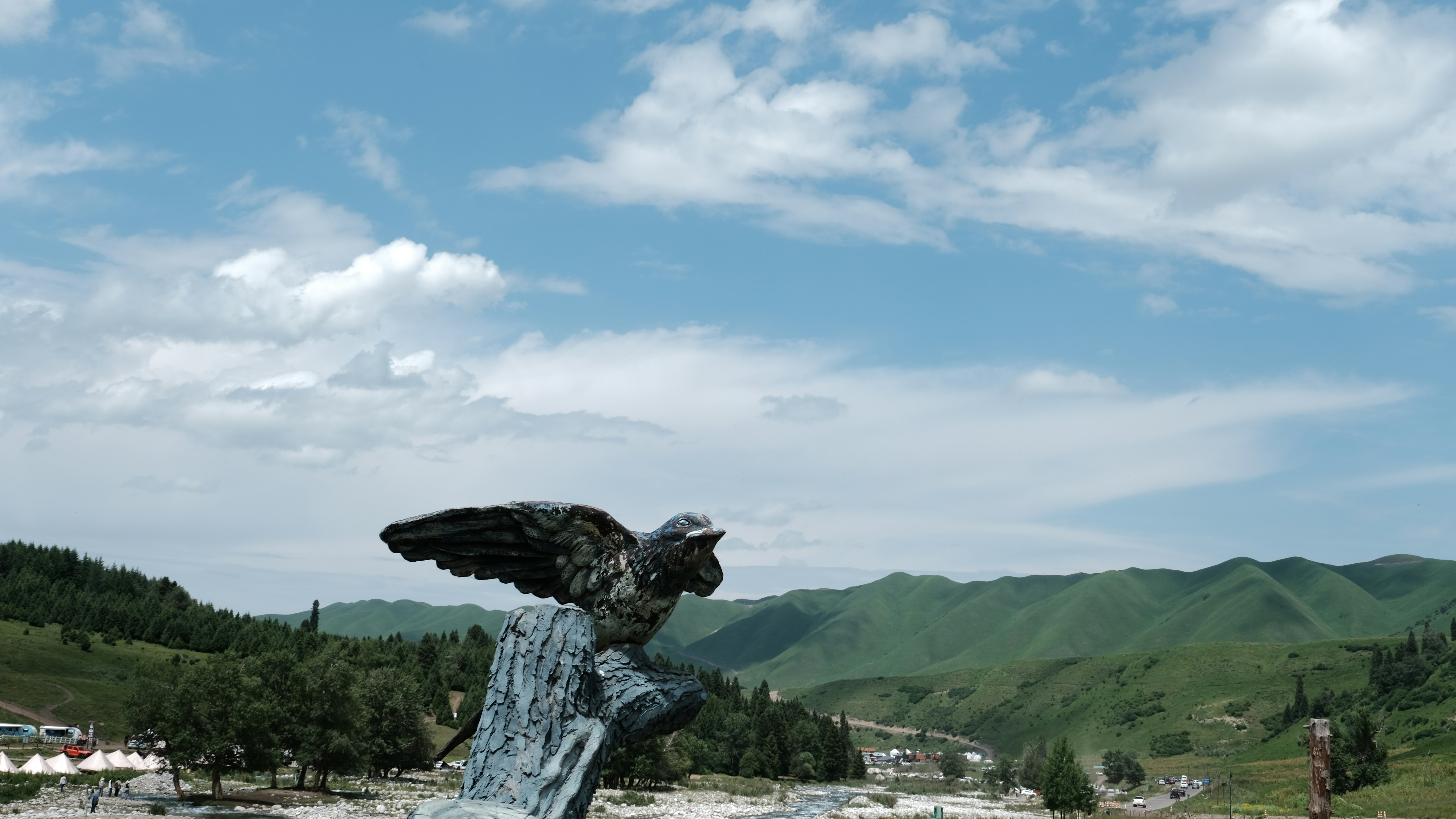 A statue of a bird perched on top of a rock