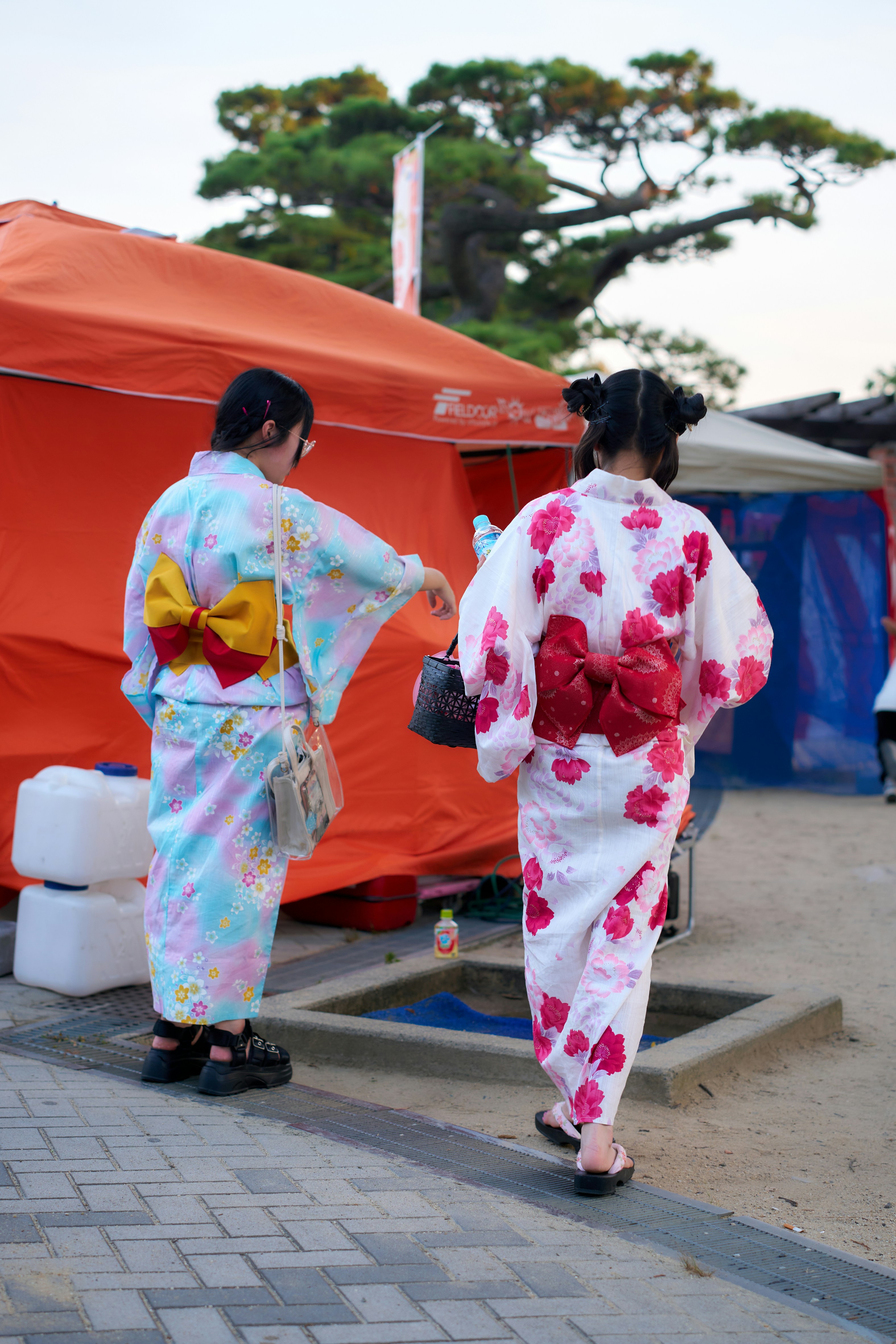 a-couple-of-women-in-kimonos-walking-down-a-street-photo-free-woman