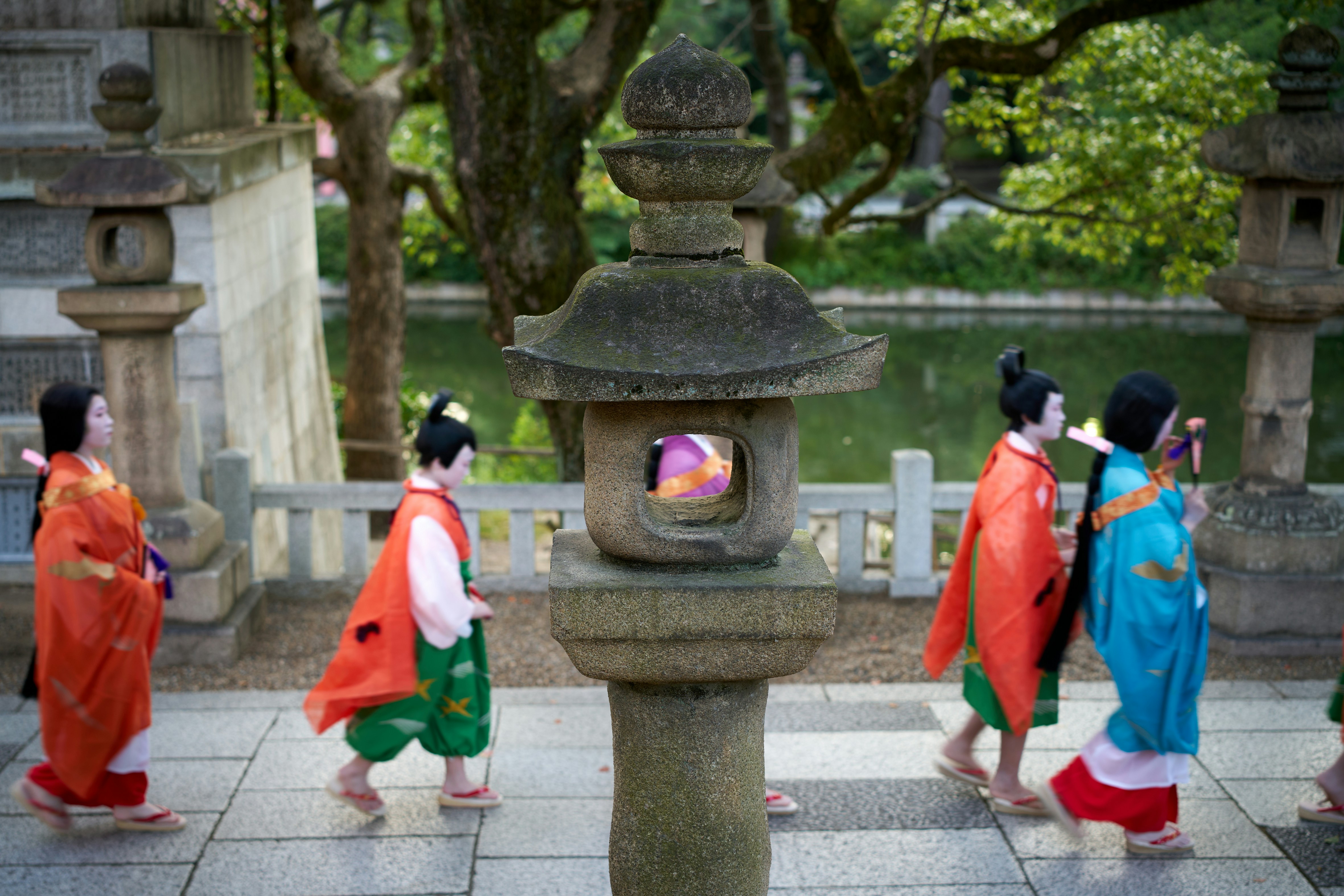 A group of people walking across a stone walkway