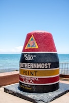 A large red and black cone sitting on top of a cement slab