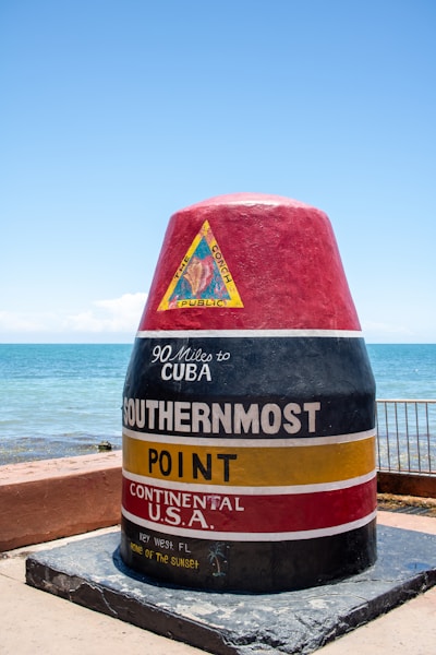 A large red and black cone sitting on top of a cement slab