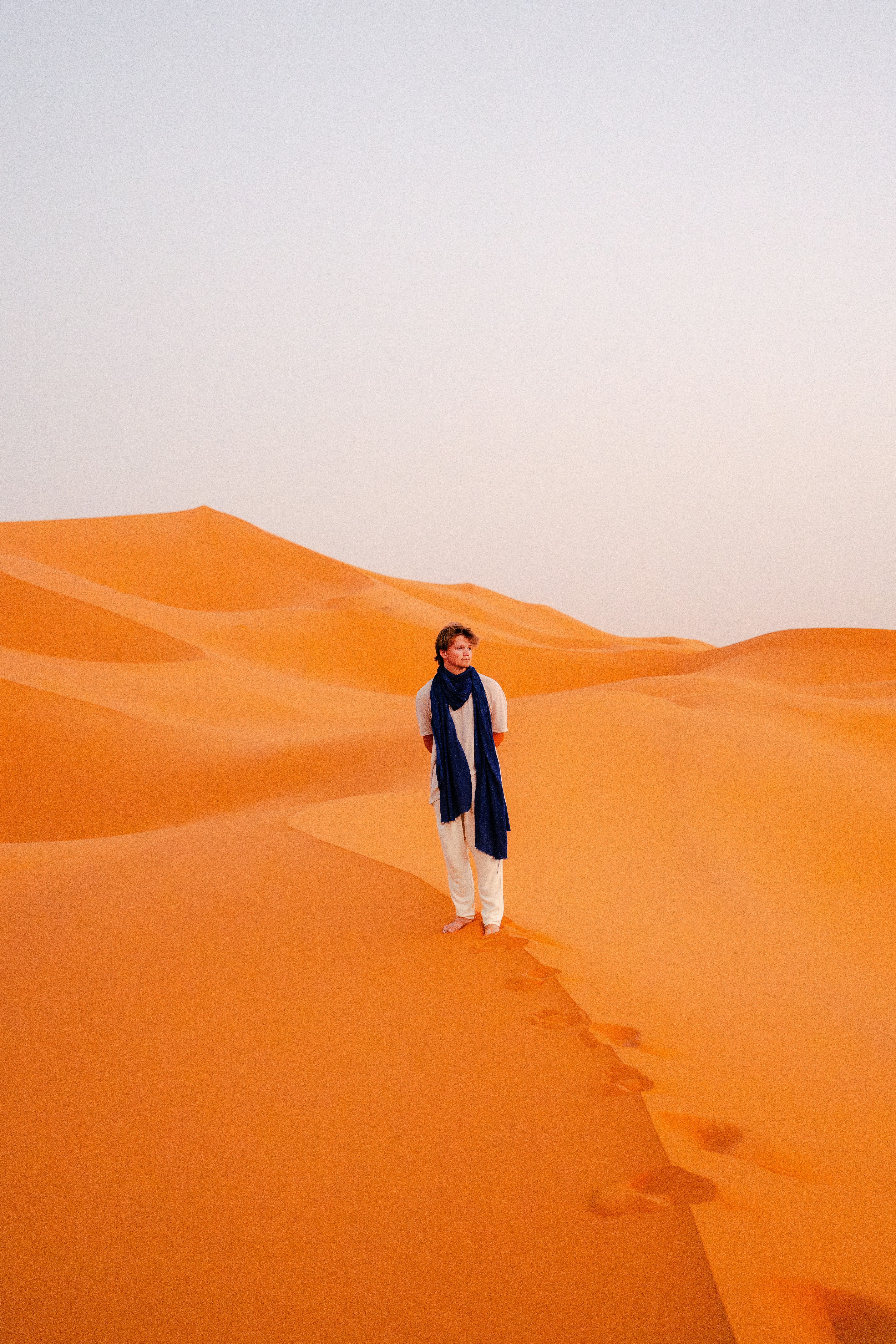 A man standing in the middle of a desert