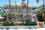 A white house with palm trees in front of it