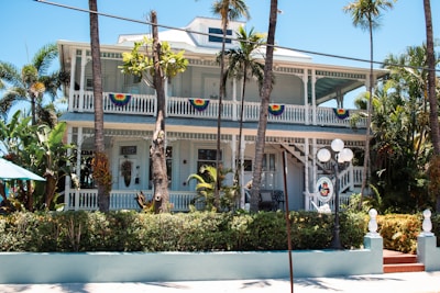 A white house with palm trees in front of it